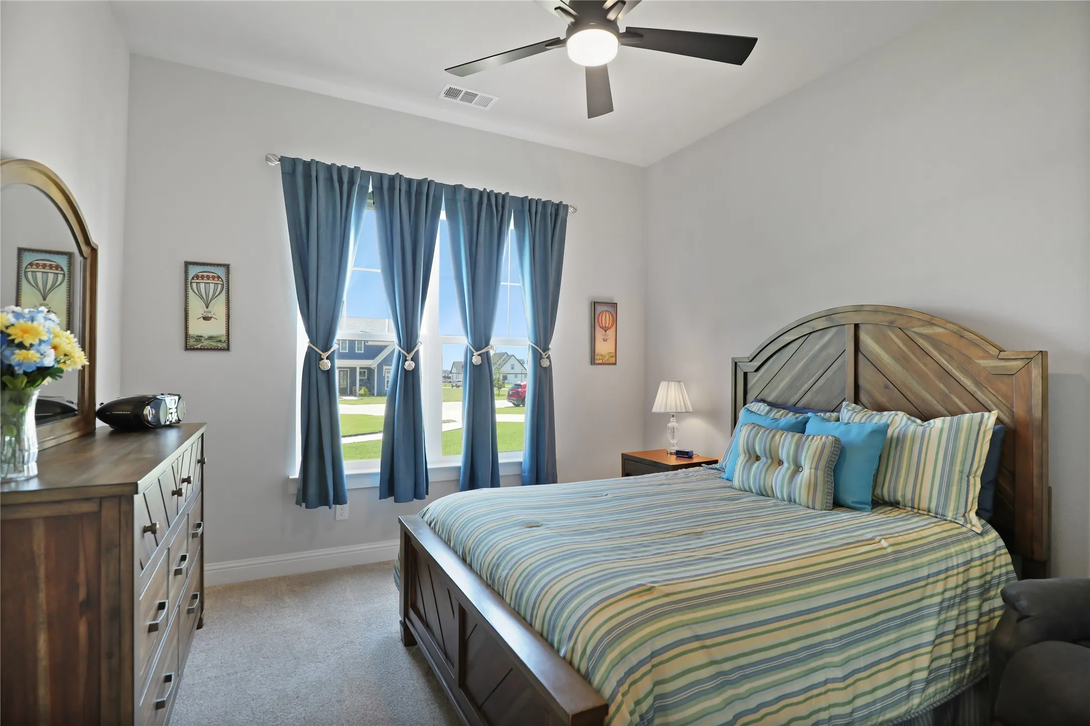 Bedroom with light carpet and ceiling fan