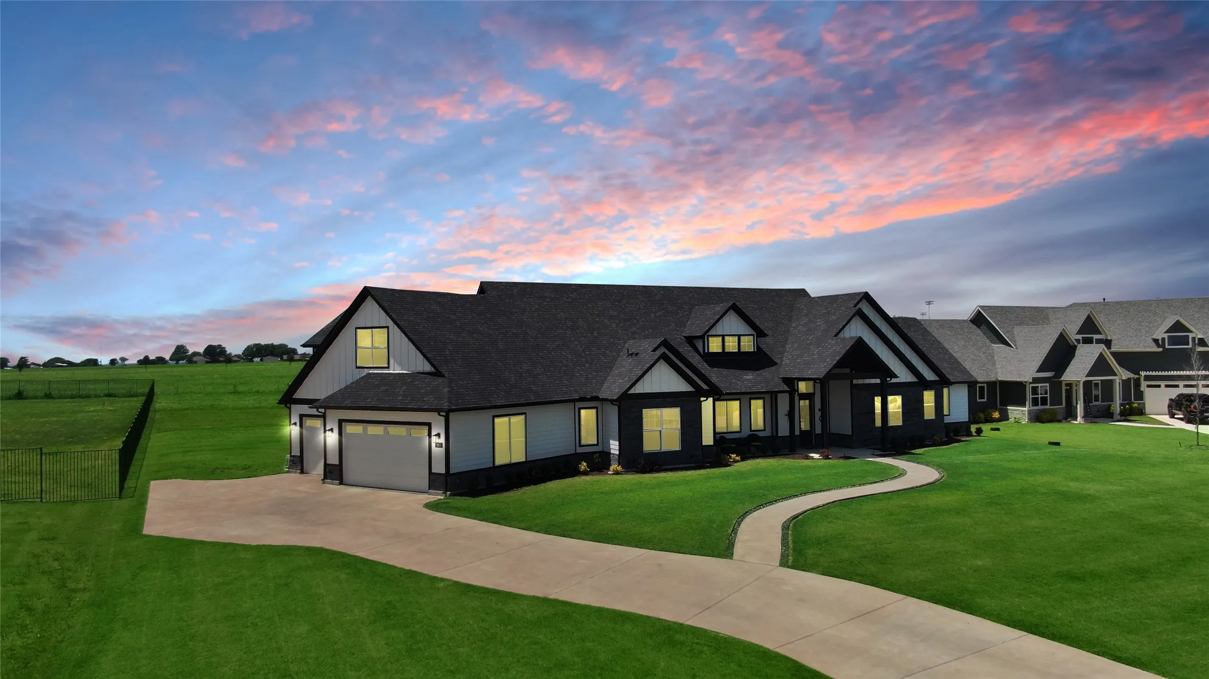 Modern inspired farmhouse featuring roof with shingles, board and batten siding, concrete driveway, and a garage
