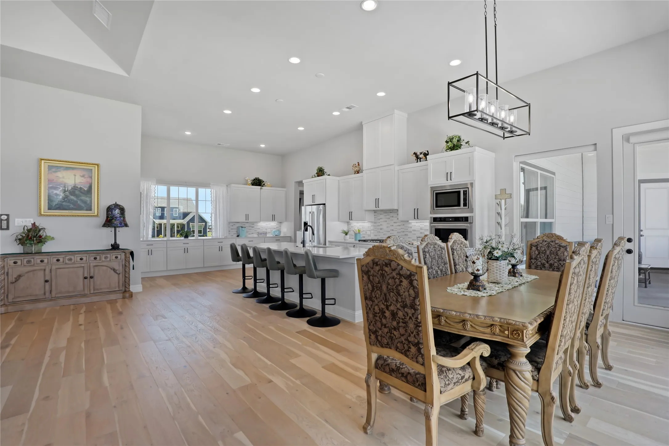Dining area with light wood finished floors and recessed lighting