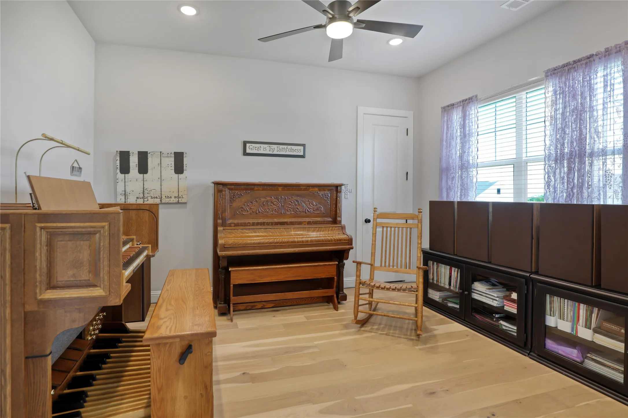 Sitting room with light wood-type flooring, recessed lighting, and a ceiling fan
