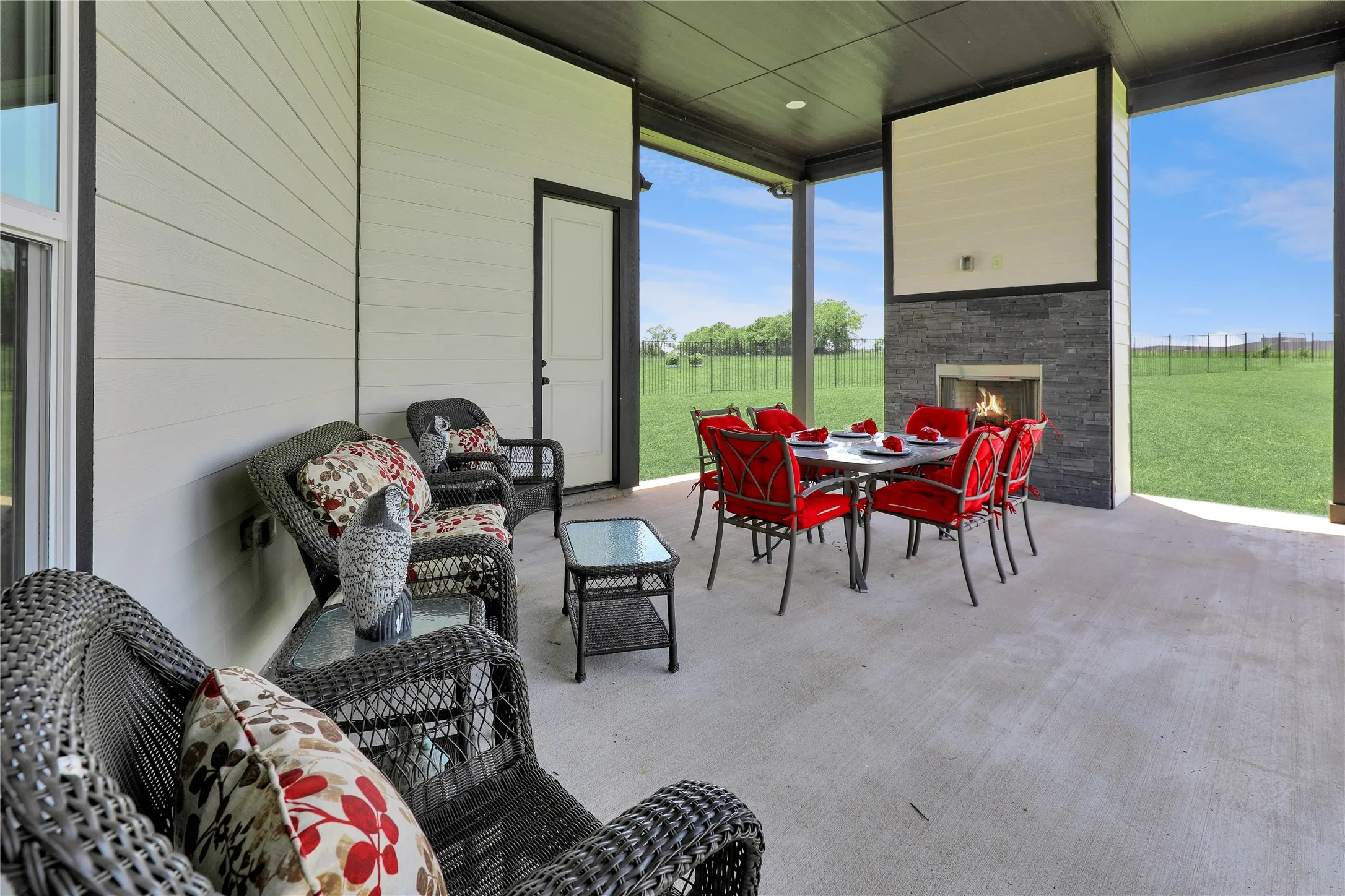 View of patio with outdoor dining space and an outdoor living space with a fireplace
