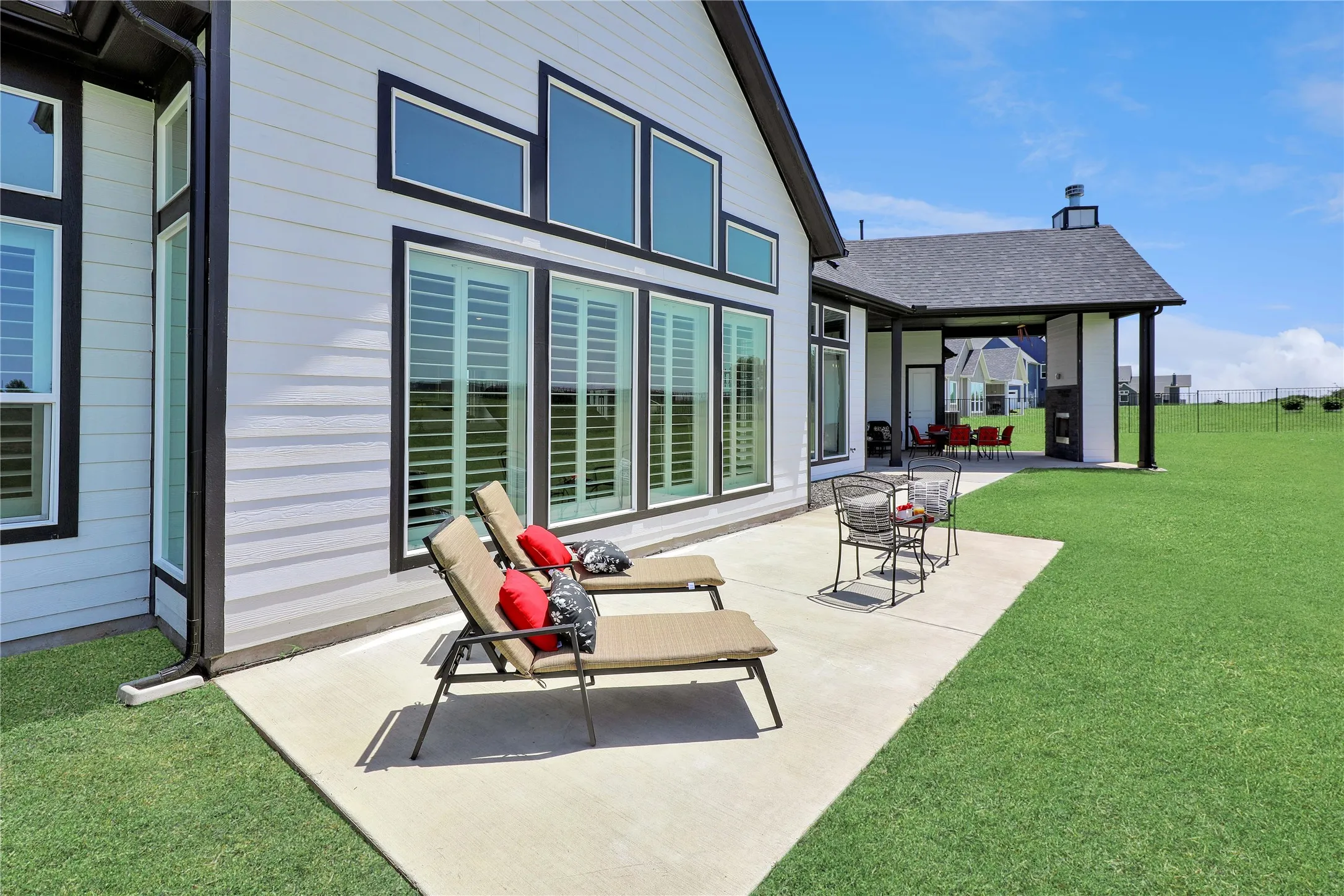 Rear view of property with a lawn and a patio
