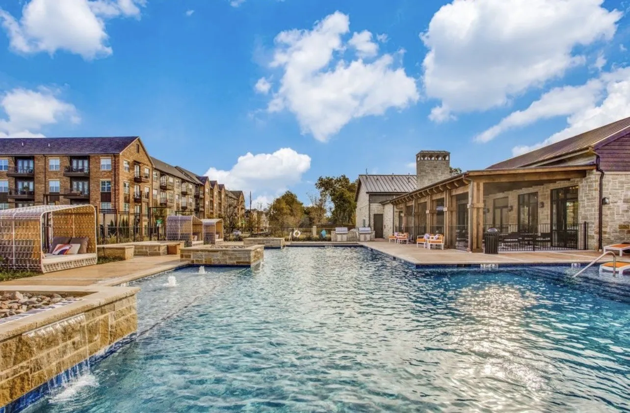 Community pool featuring cabana seating and a patio and dining area