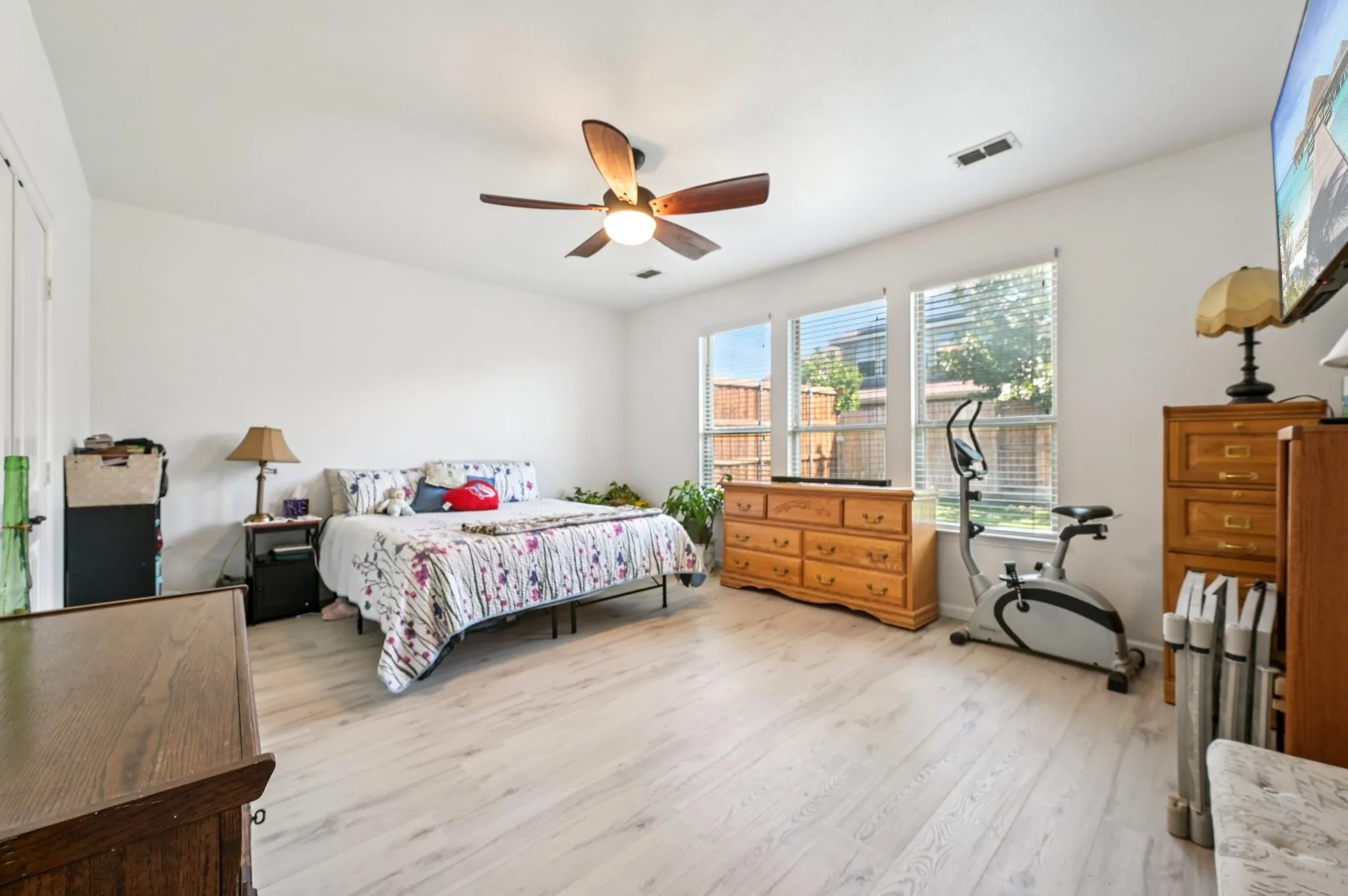 Bedroom with light wood-type flooring and a ceiling fan