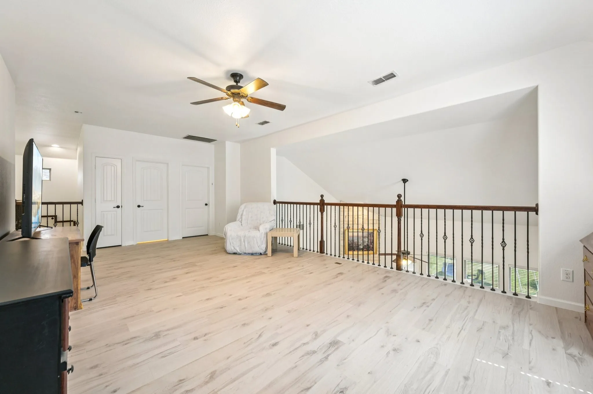 Unfurnished office with light wood-style floors and a ceiling fan