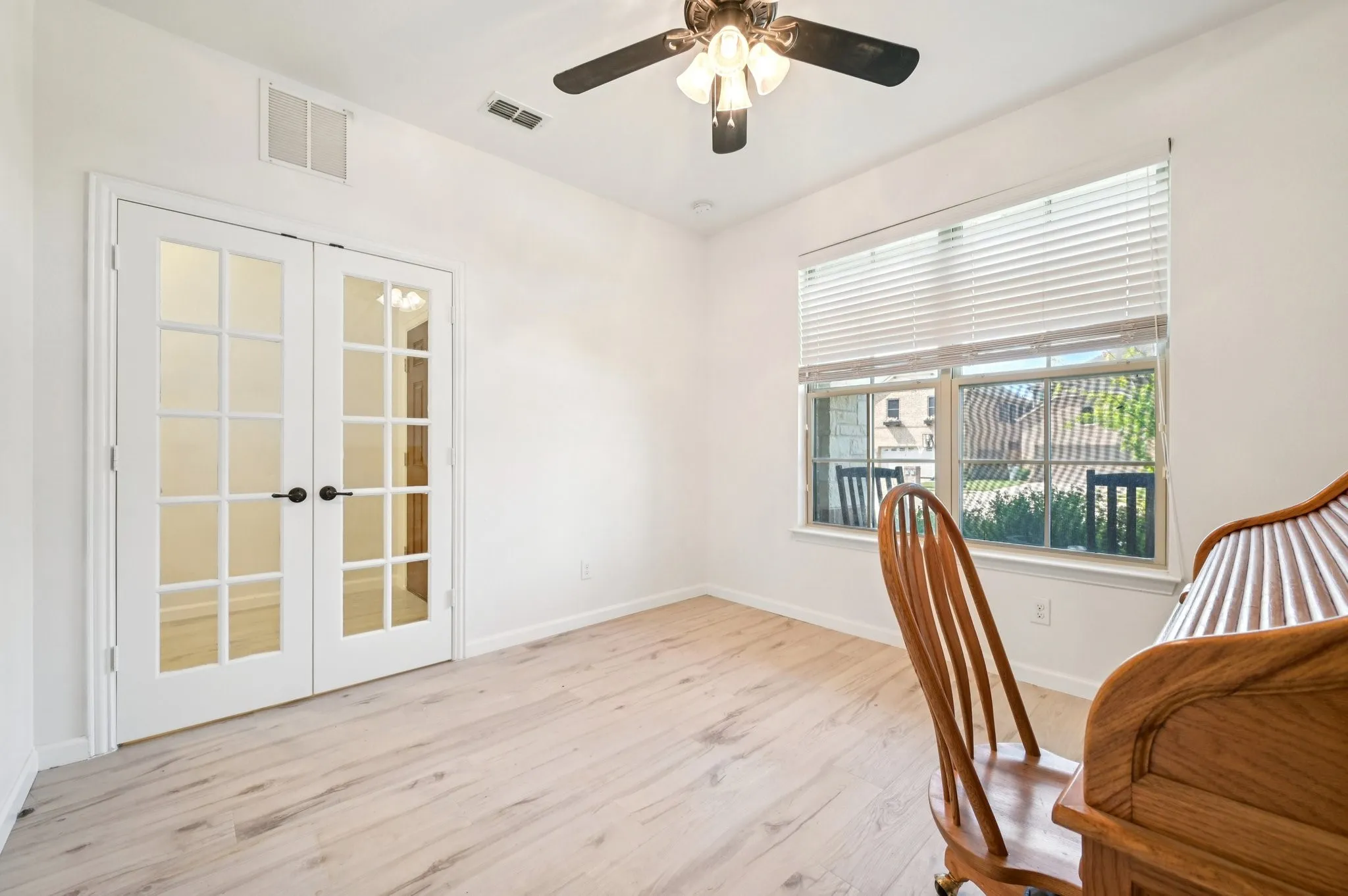 Home office featuring french doors and light wood-style flooring