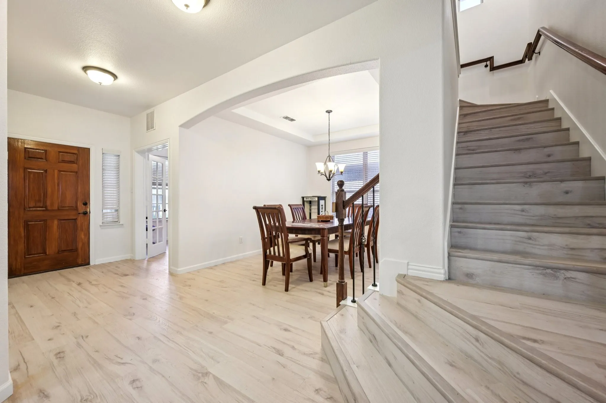 Entrance foyer with stairs, light wood-style flooring