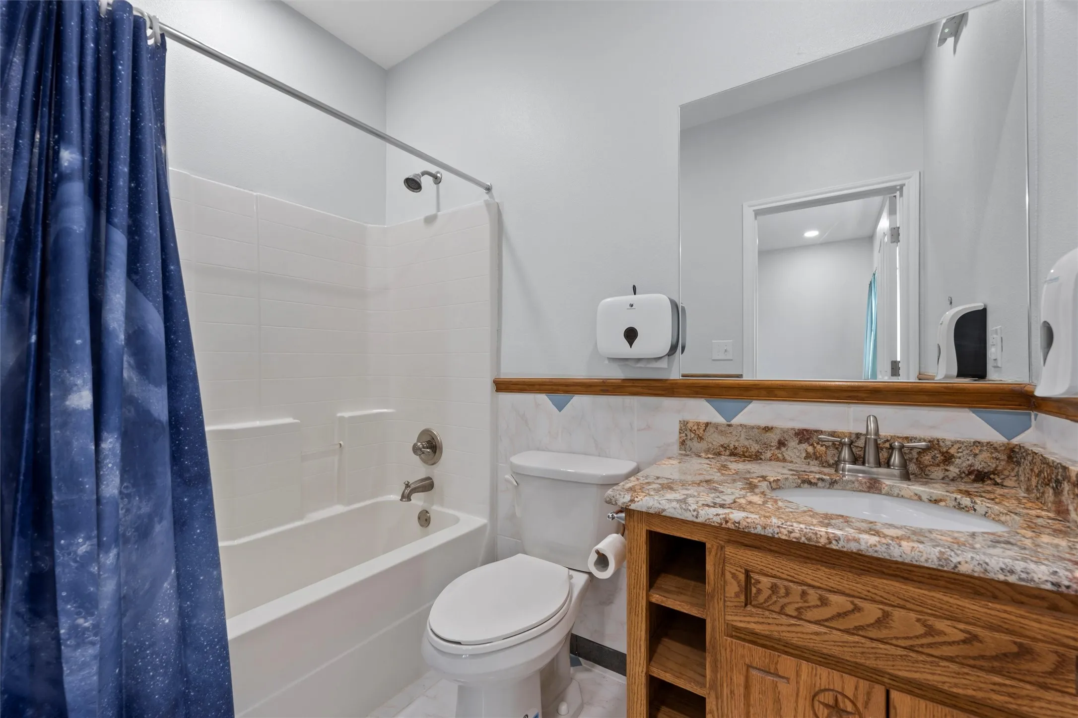 Full bathroom with shower / bath combo with shower curtain and vanity