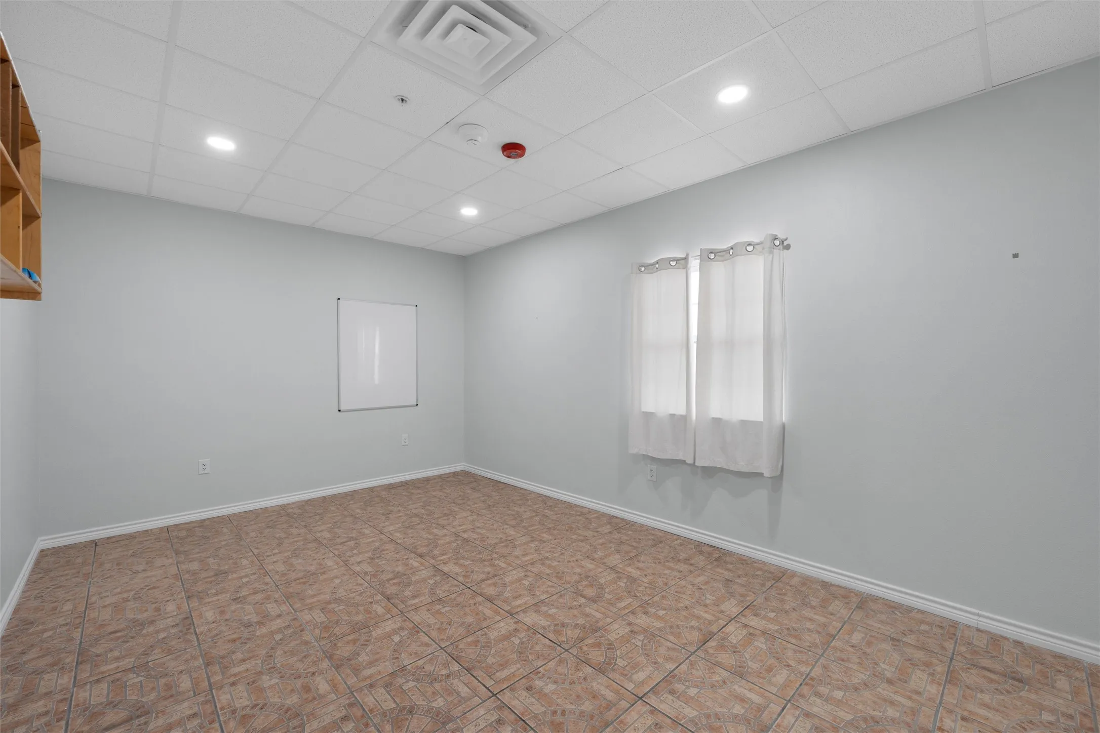 Empty room featuring a paneled ceiling and recessed lighting