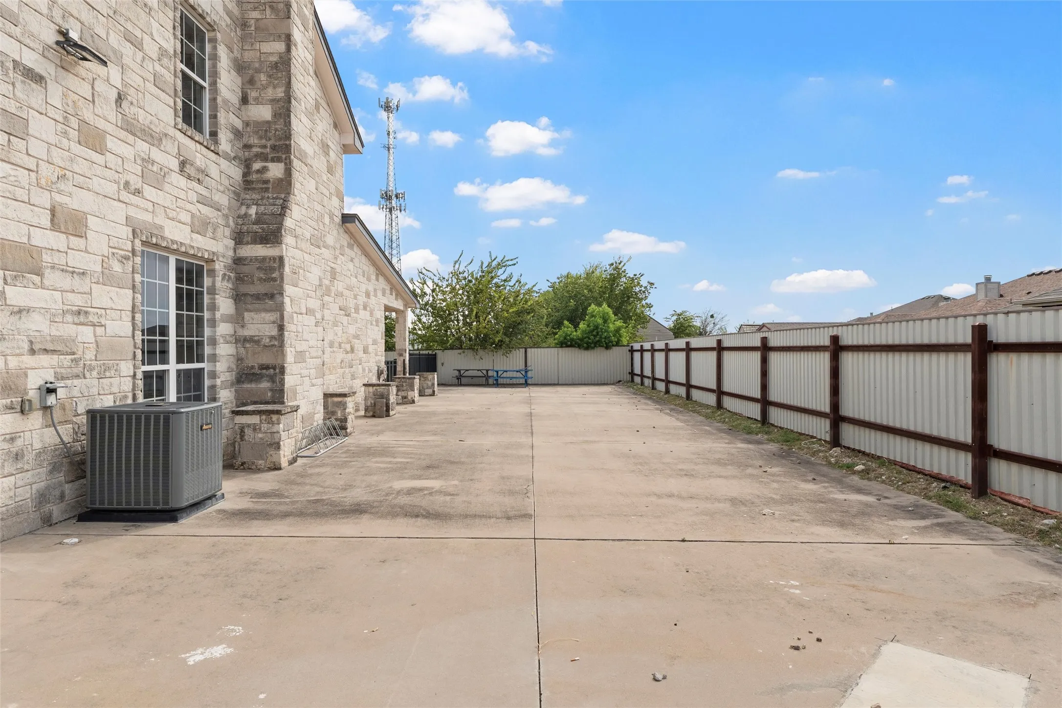 Fenced backyard with a patio