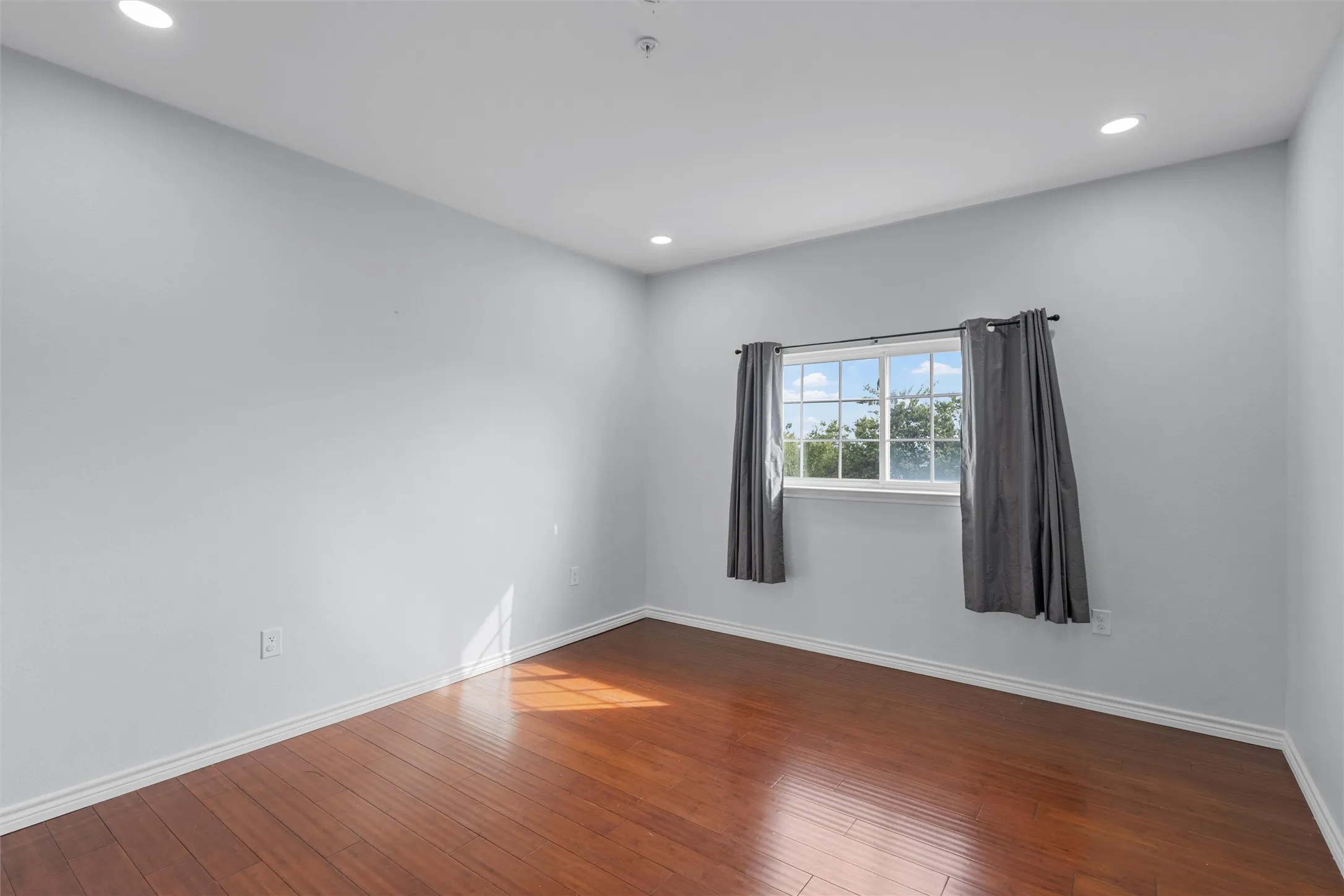 Spare room with recessed lighting and dark wood-style flooring