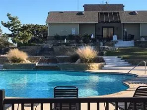 Community pool featuring a patio and a balcony