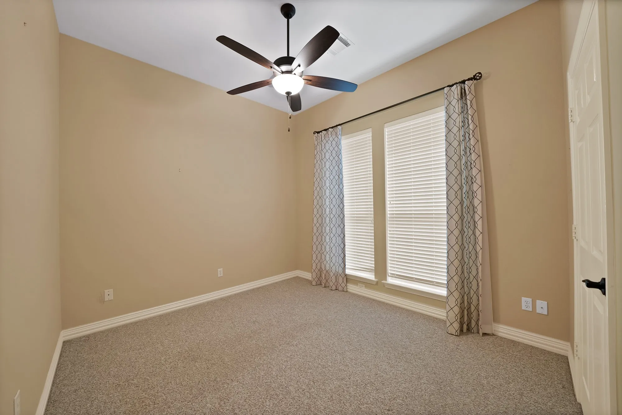 Unfurnished room featuring carpet and ceiling fan