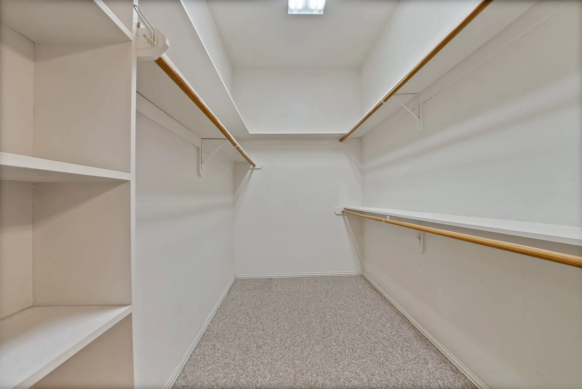 Spacious closet with light carpet