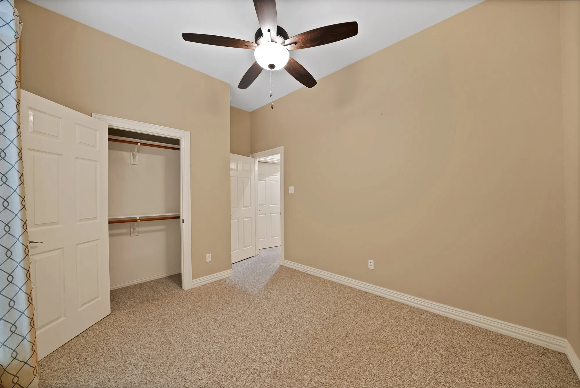 Unfurnished bedroom with carpet flooring, a closet, and ceiling fan