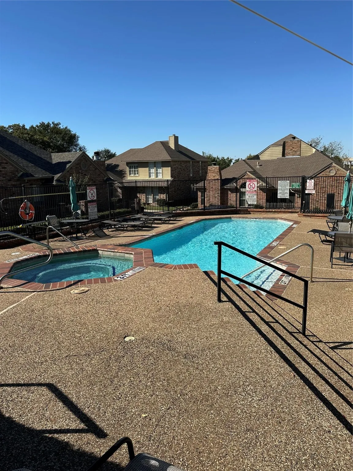 Community pool featuring a patio and a residential view