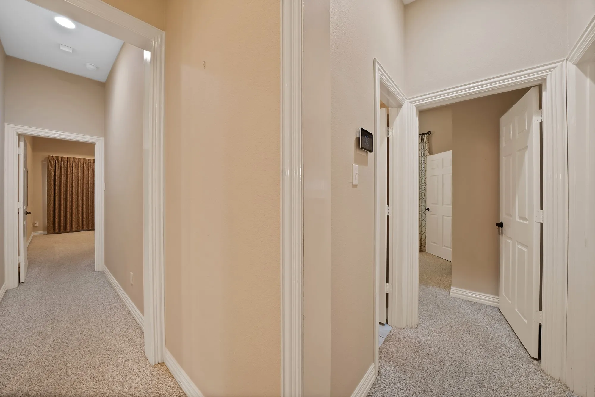 Hall with light carpet and baseboards