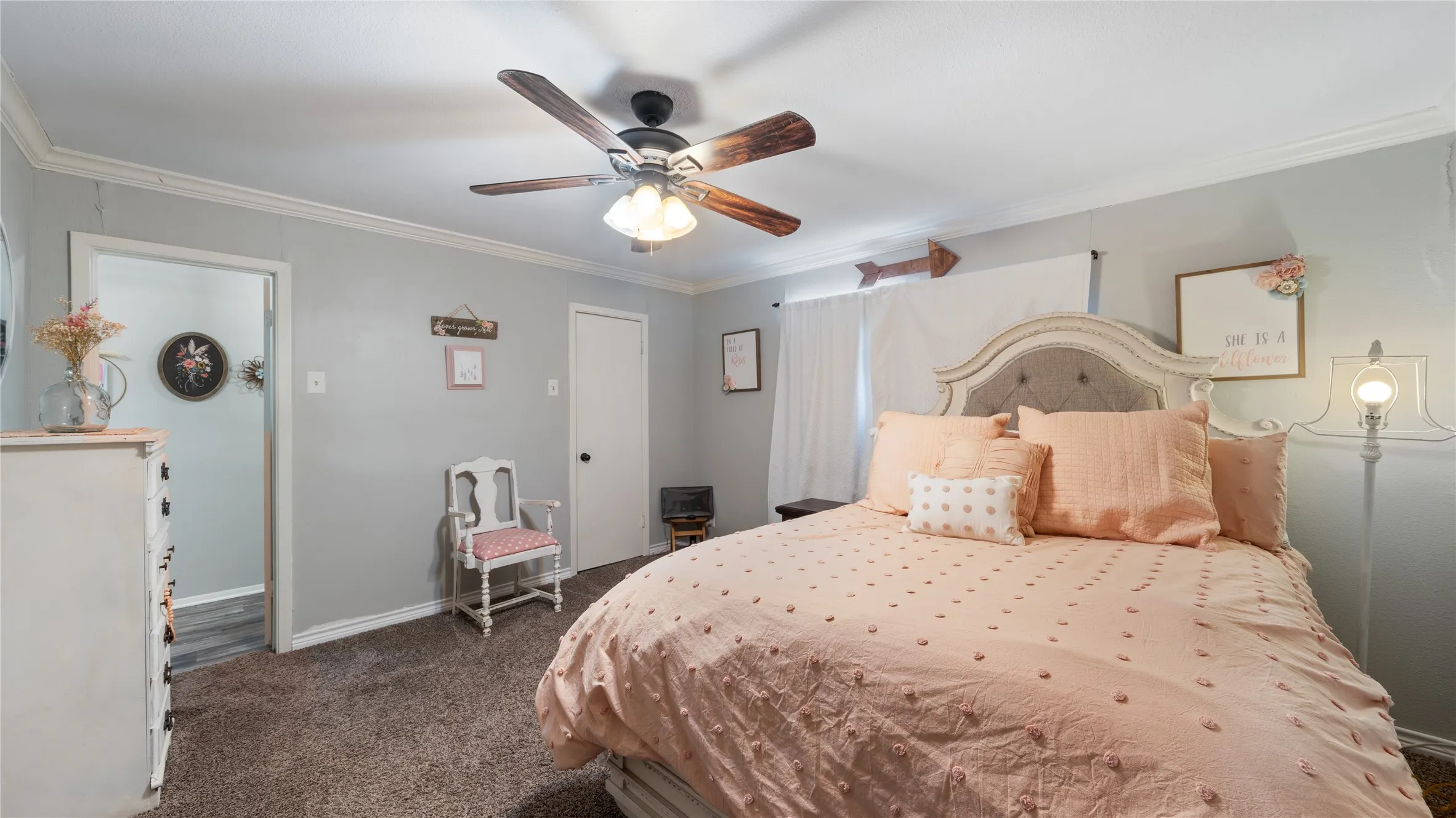 Bedroom featuring crown molding, dark carpet, and ceiling fan