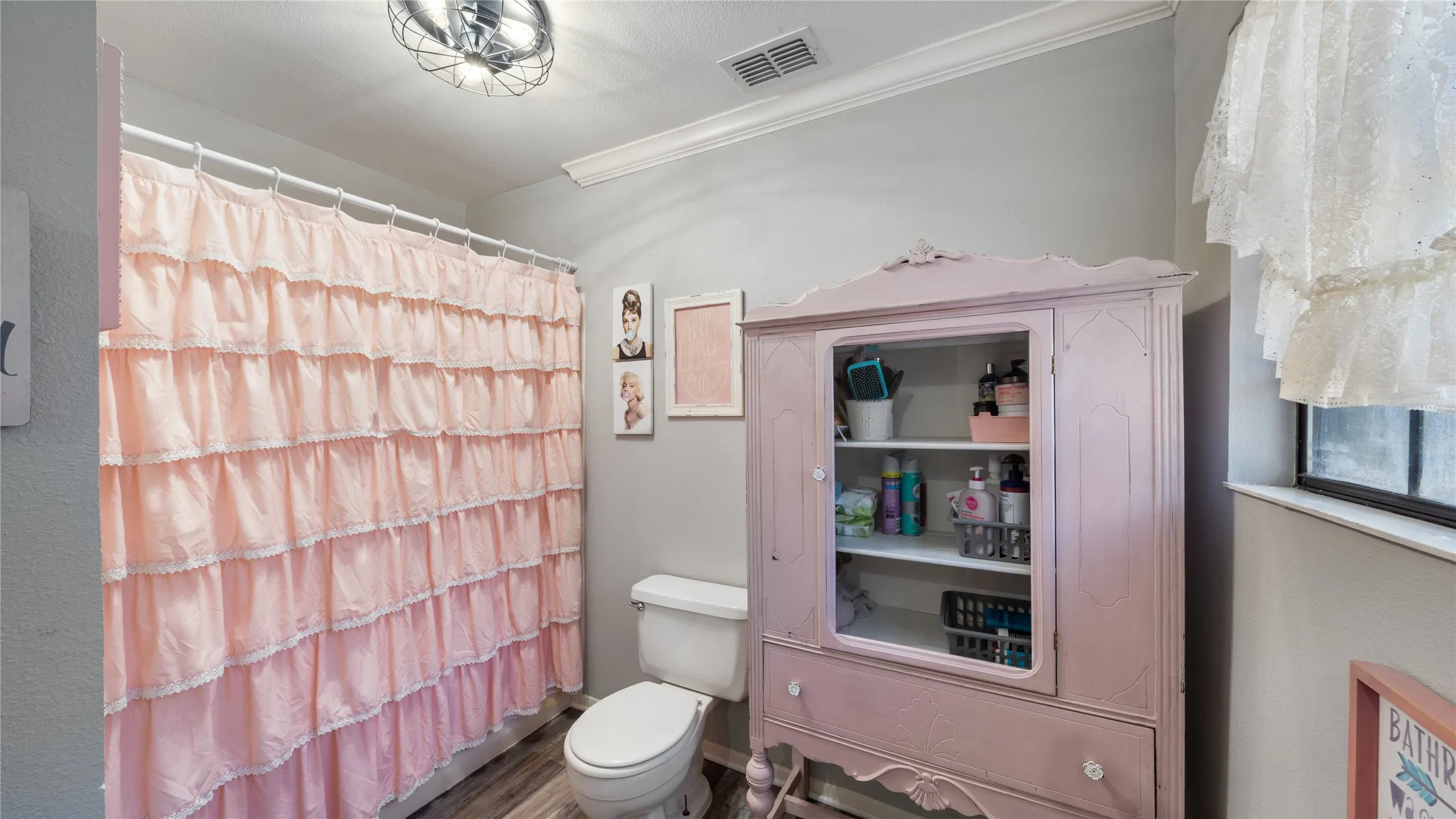 Full bath featuring ornamental molding and wood finished floors