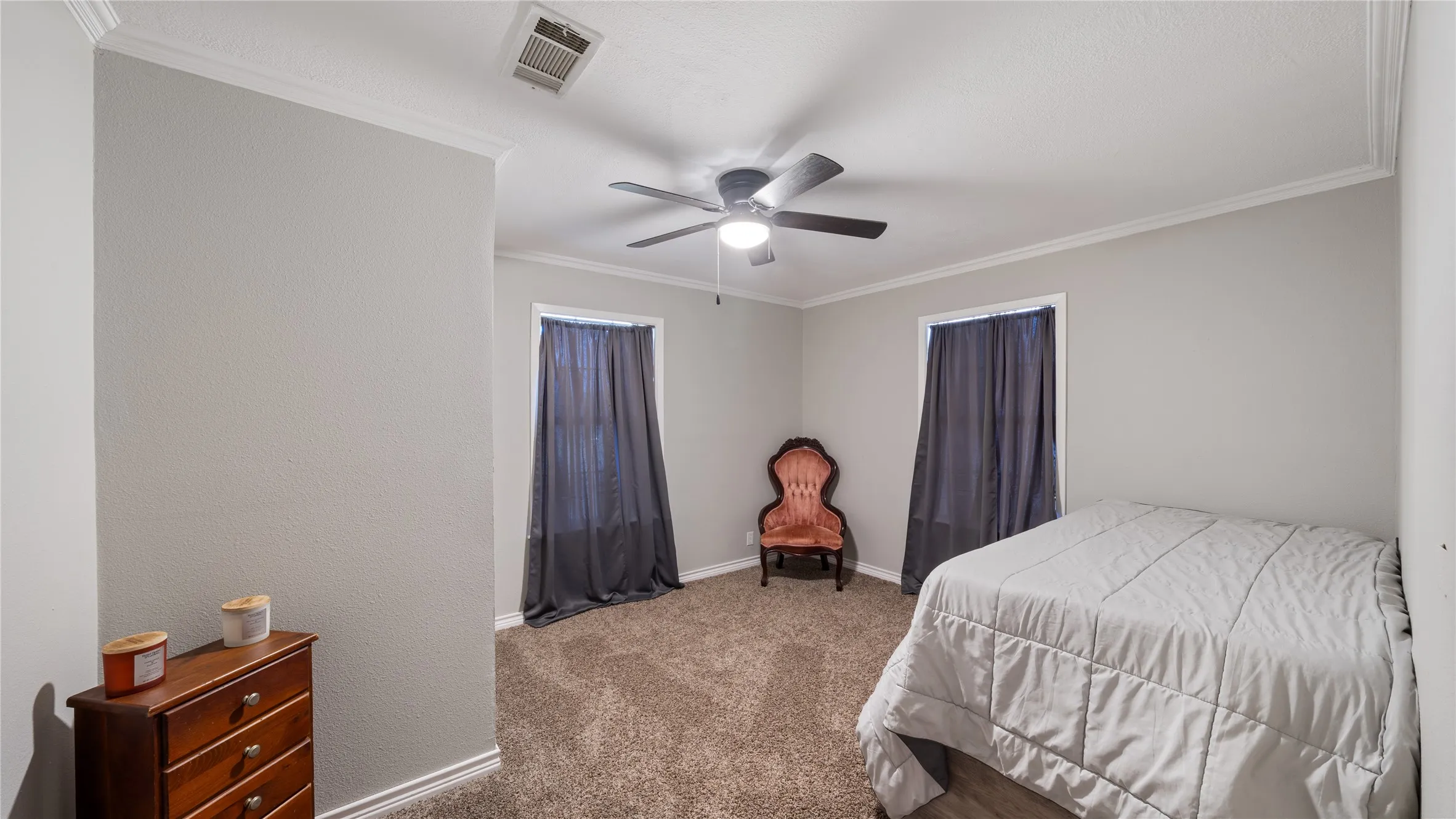 Bedroom featuring crown molding, carpet, and ceiling fan