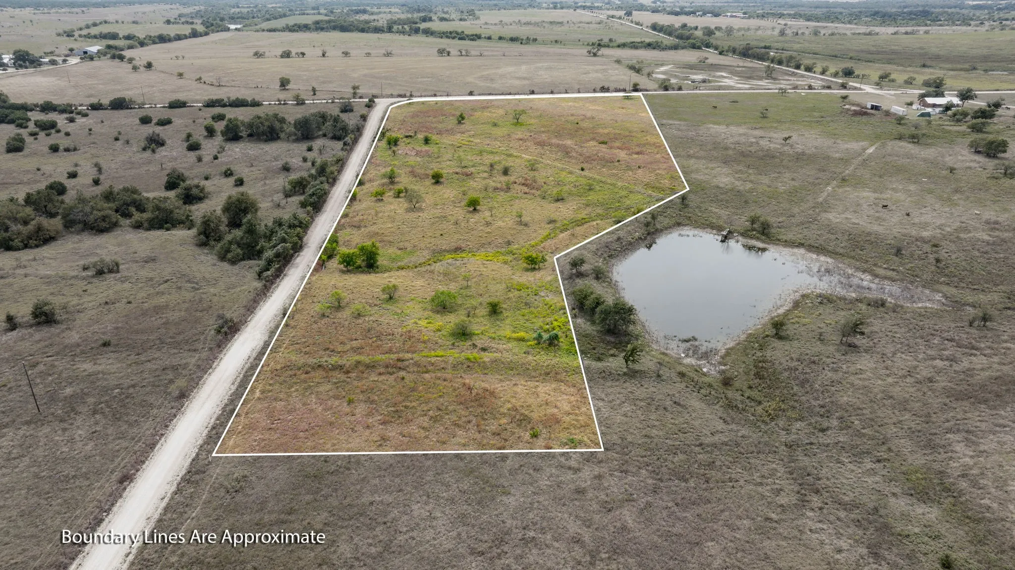 Overview of rural landscape with property parcel outlined and a nearby body of water