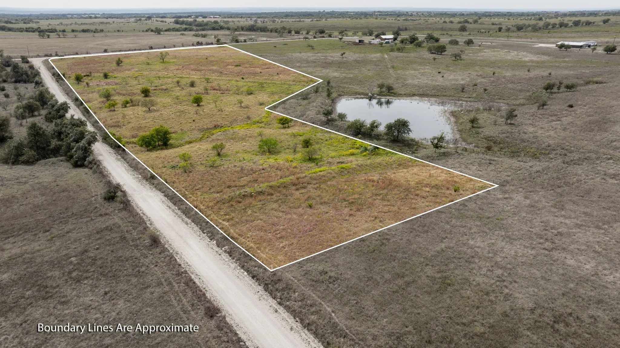 Overview of rural landscape featuring property boundaries highlighted and a large body of water