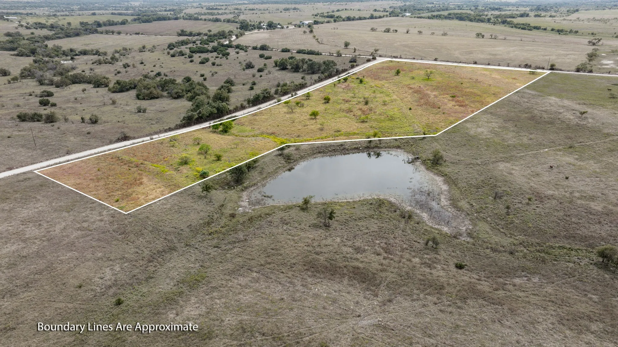 View of rural area with a nearby body of water and property parcel outlined