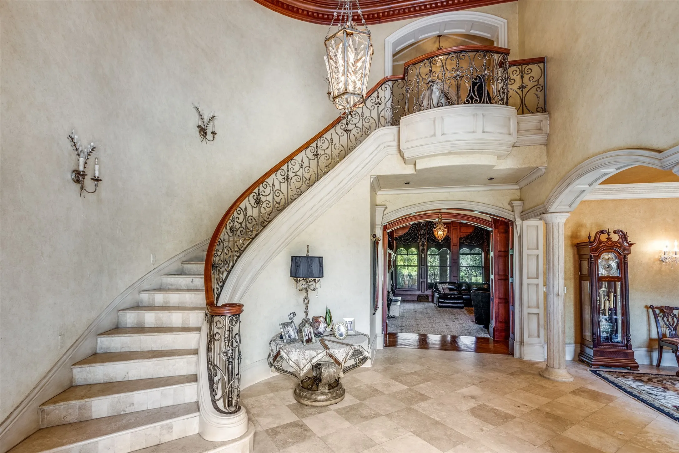 Striking Staircase with Travertine Marble and Custom Iron Work