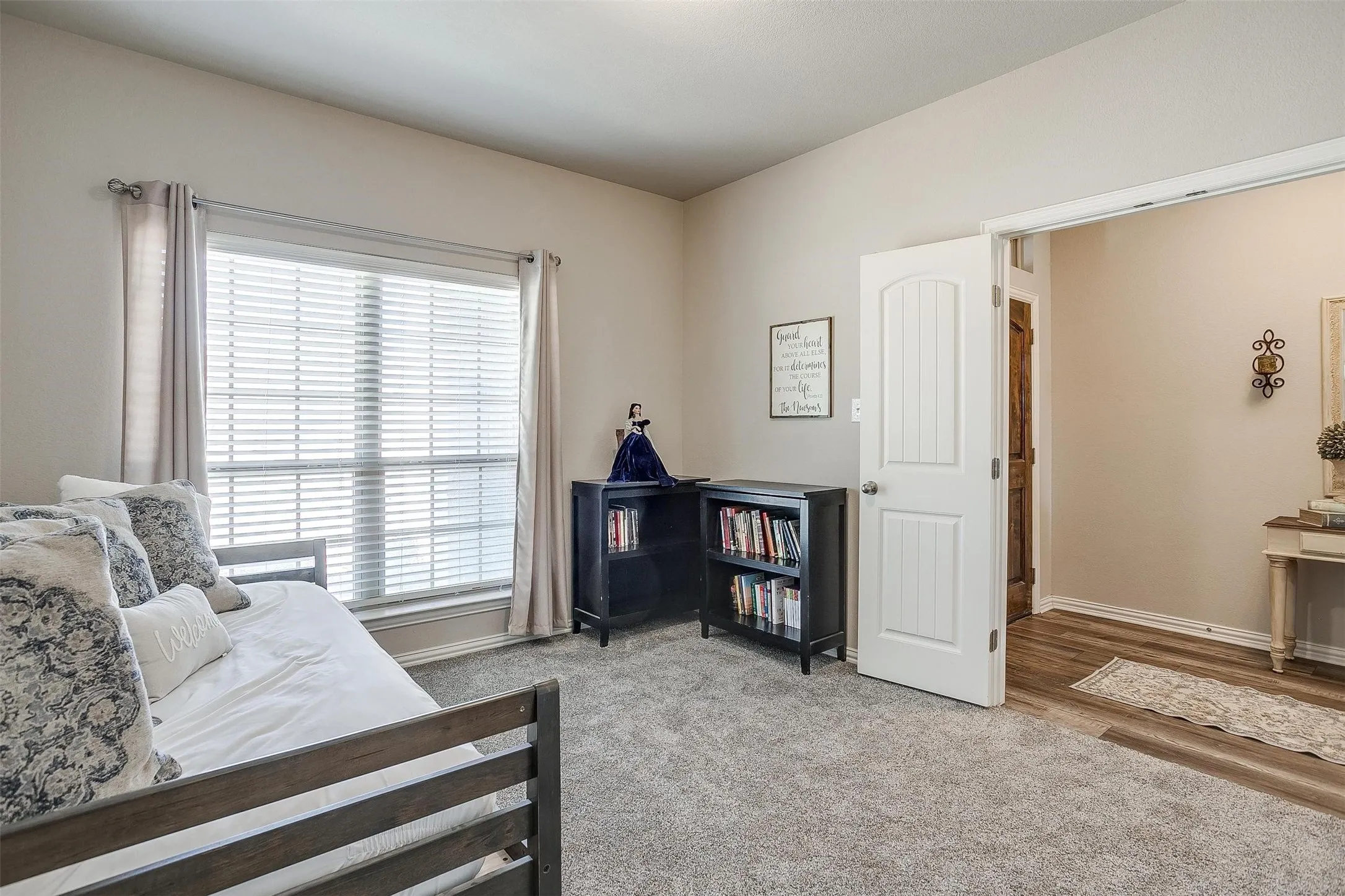 4th bedroom or office space featuring light colored carpet and baseboards