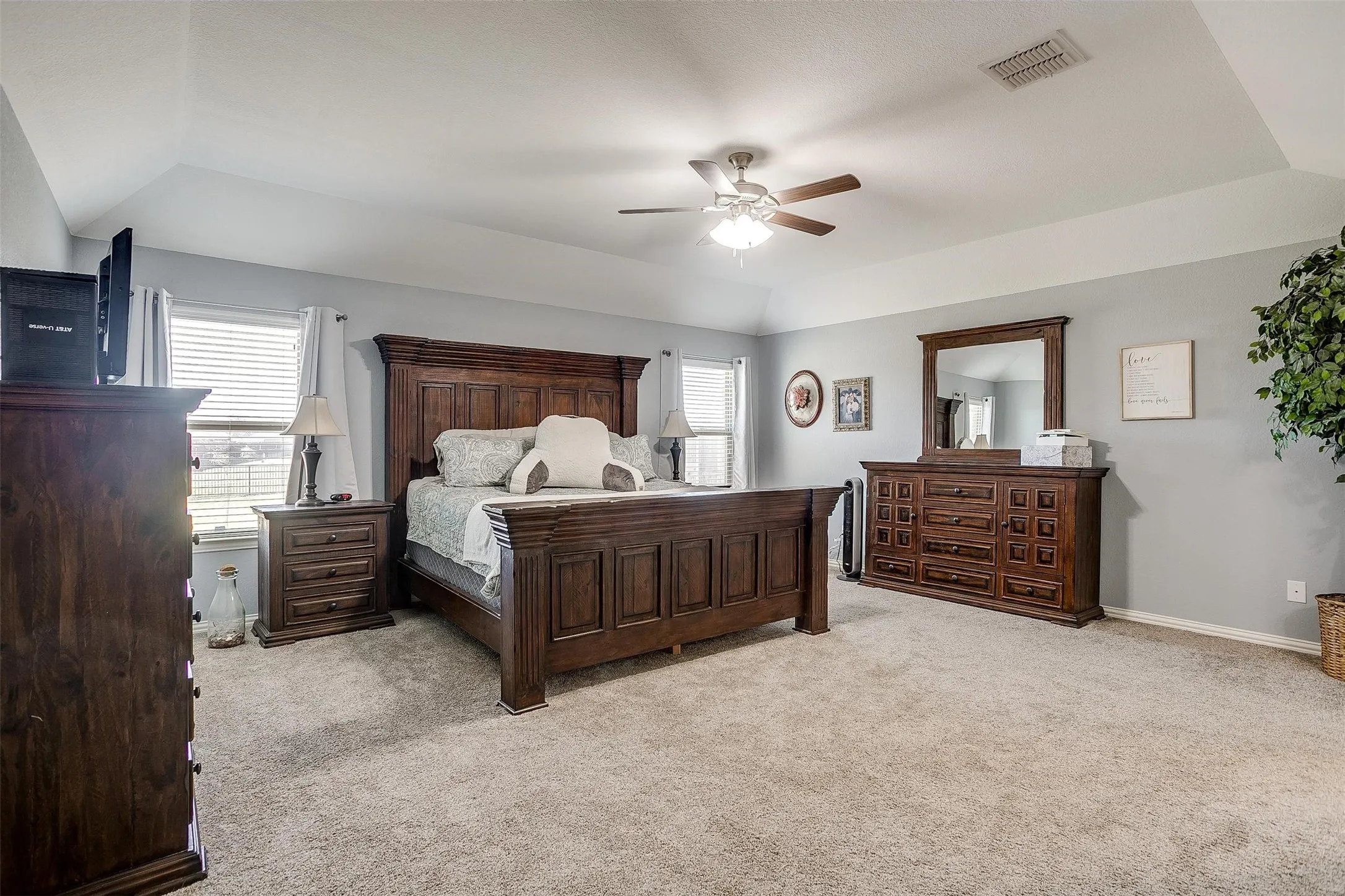 Bedroom featuring light colored carpet, a ceiling fan, and lofted ceiling