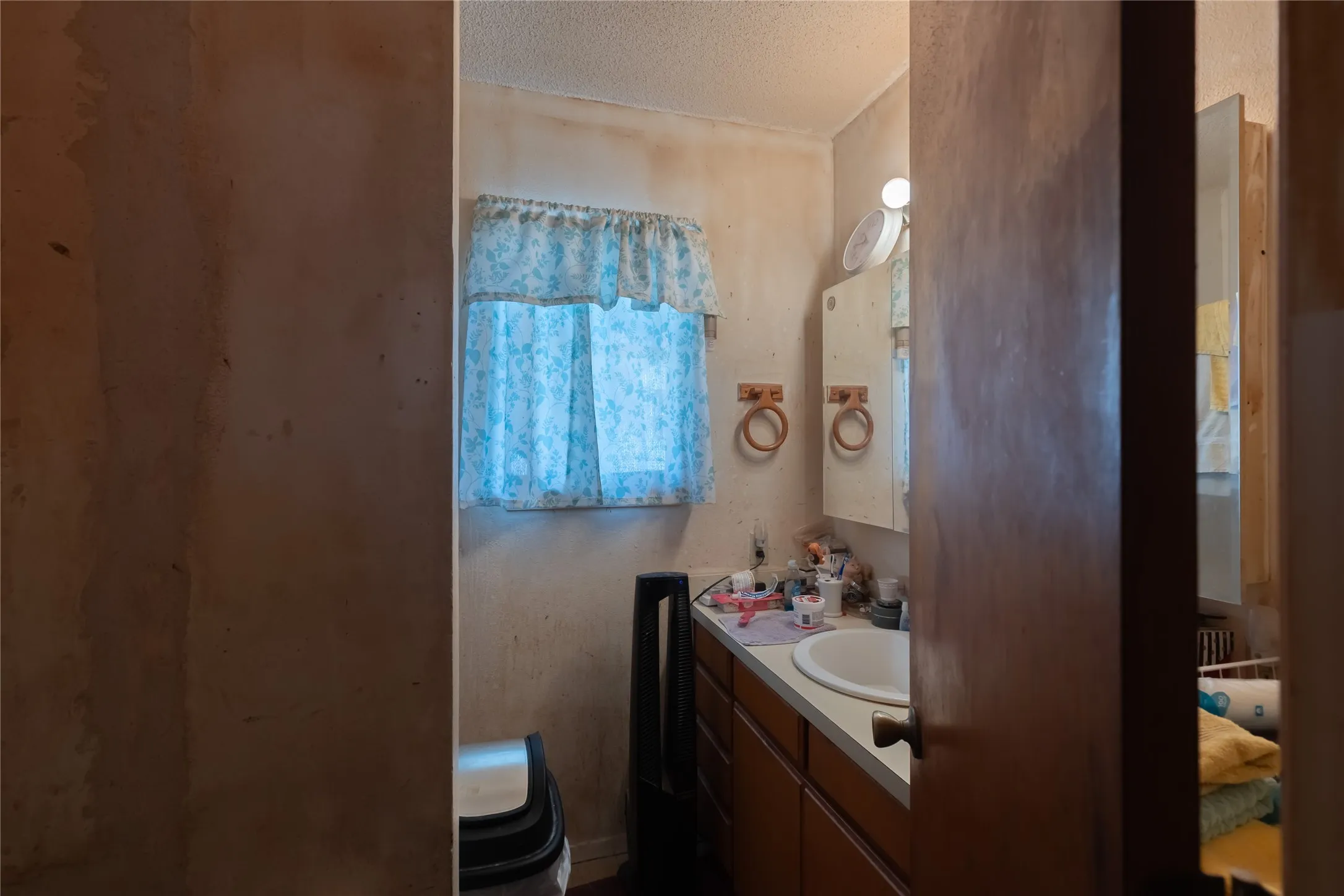 Bathroom with vanity and a textured ceiling