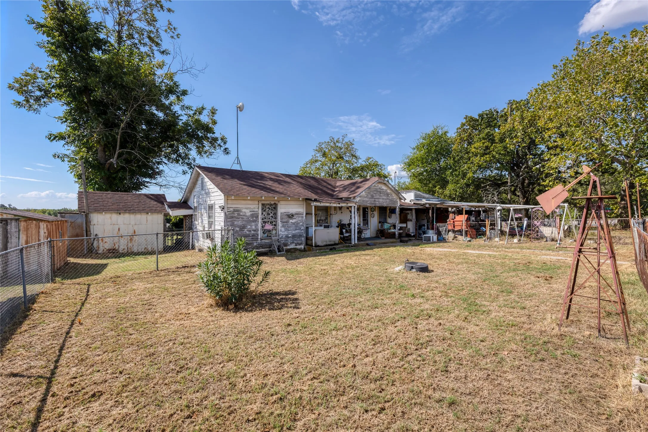 view of property featuring a fenced backyard and an outbuilding