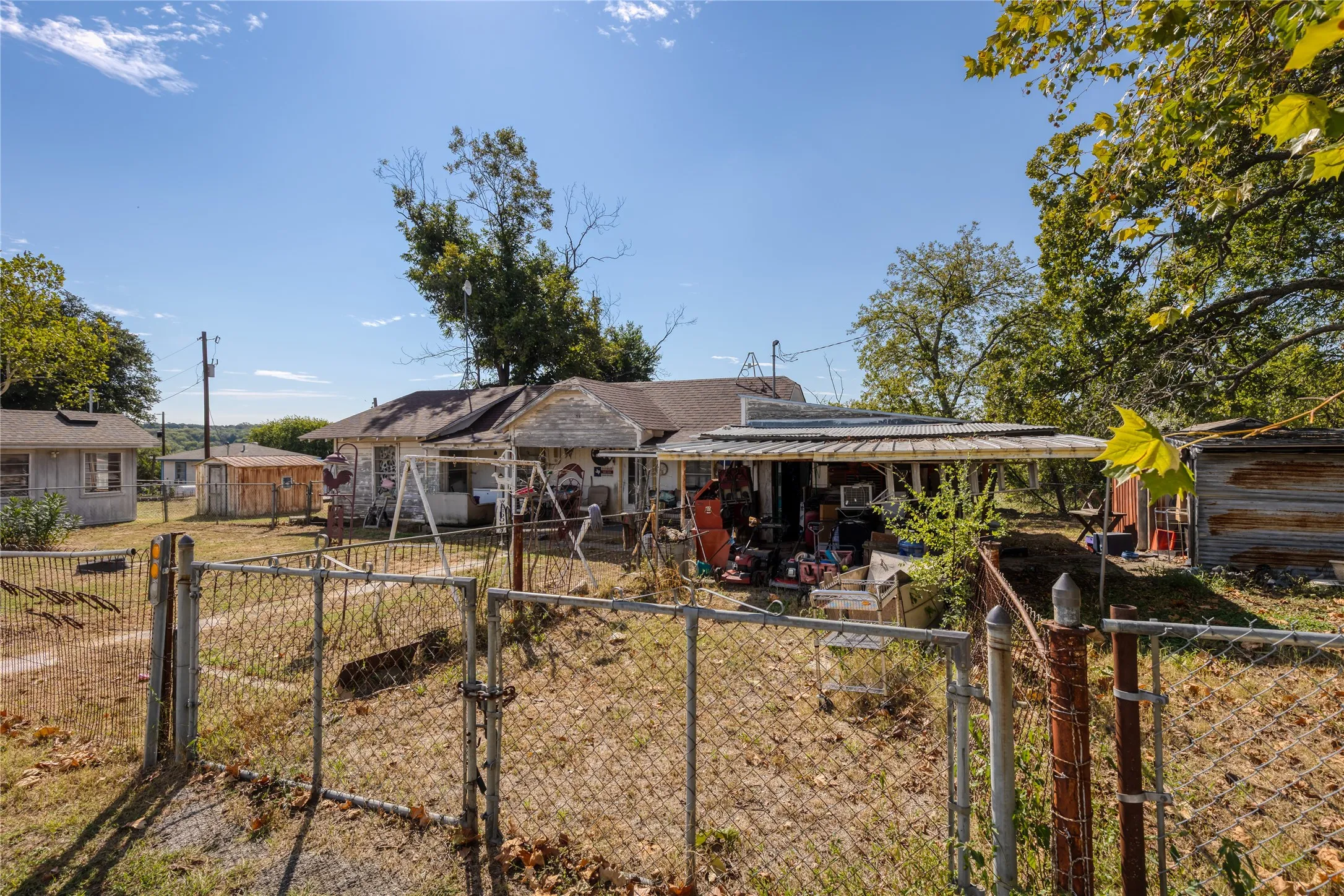 View of front facade featuring a fenced front yard, a gate, and a patio