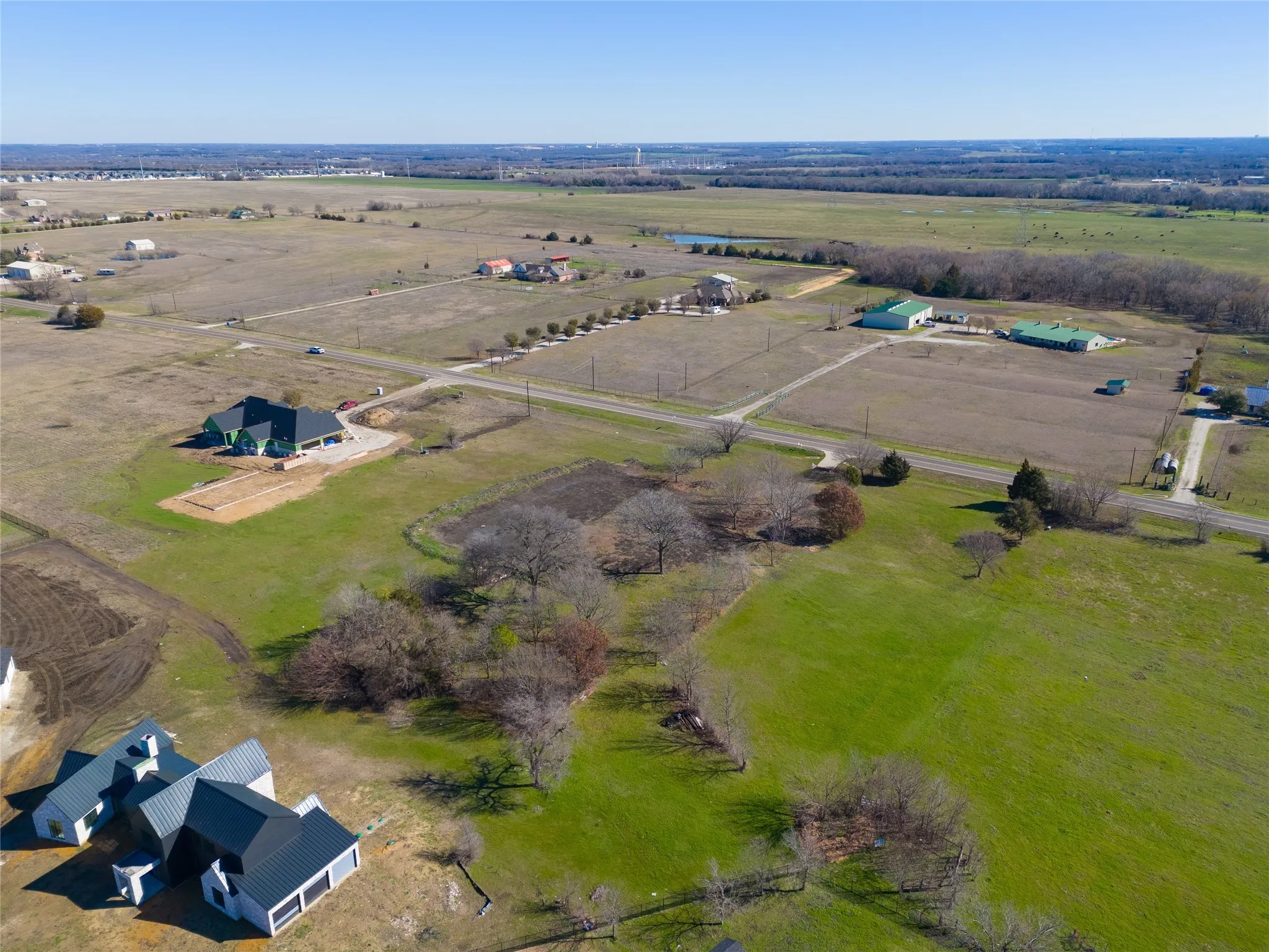 Aerial view of property and surrounding area featuring rural landscape