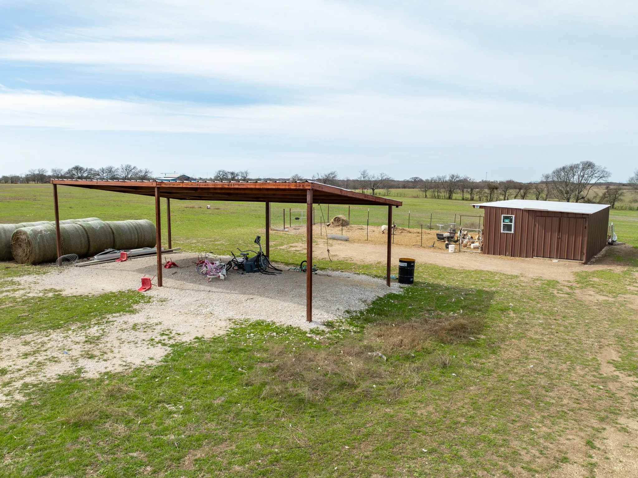 View of green lawn with a rural view and an outbuilding