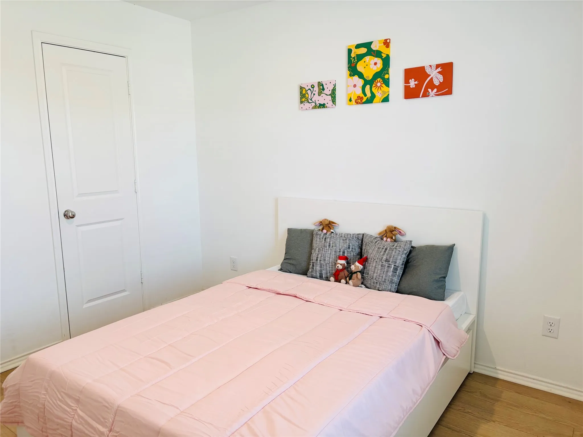 Bedroom featuring wood finished floors and baseboards