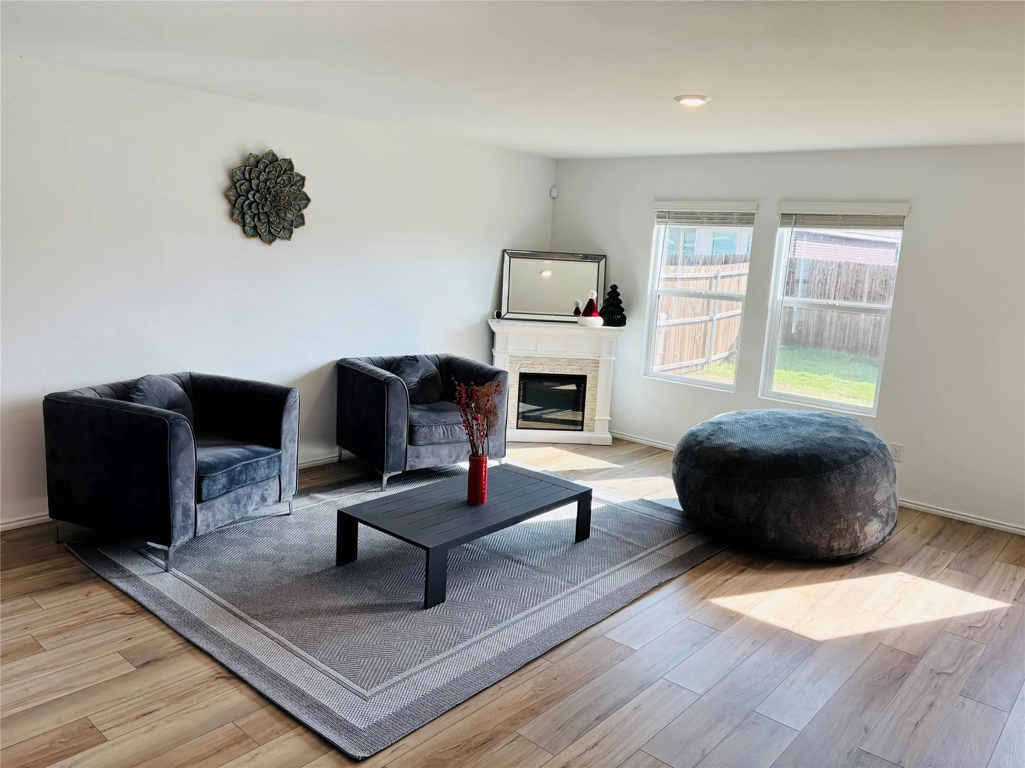 Living area featuring a glass covered fireplace and light wood-type flooring