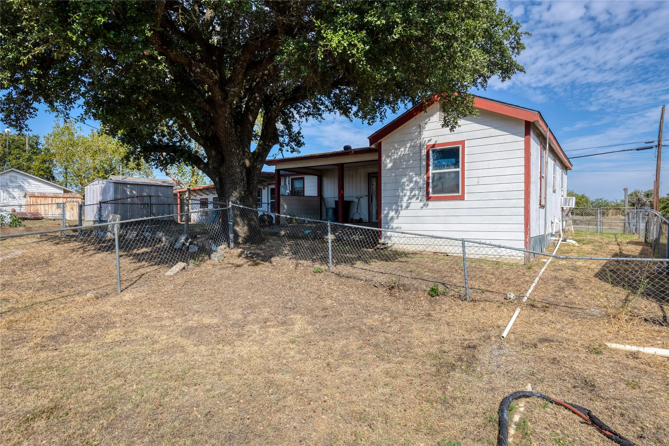 Back of house with a fenced backyard