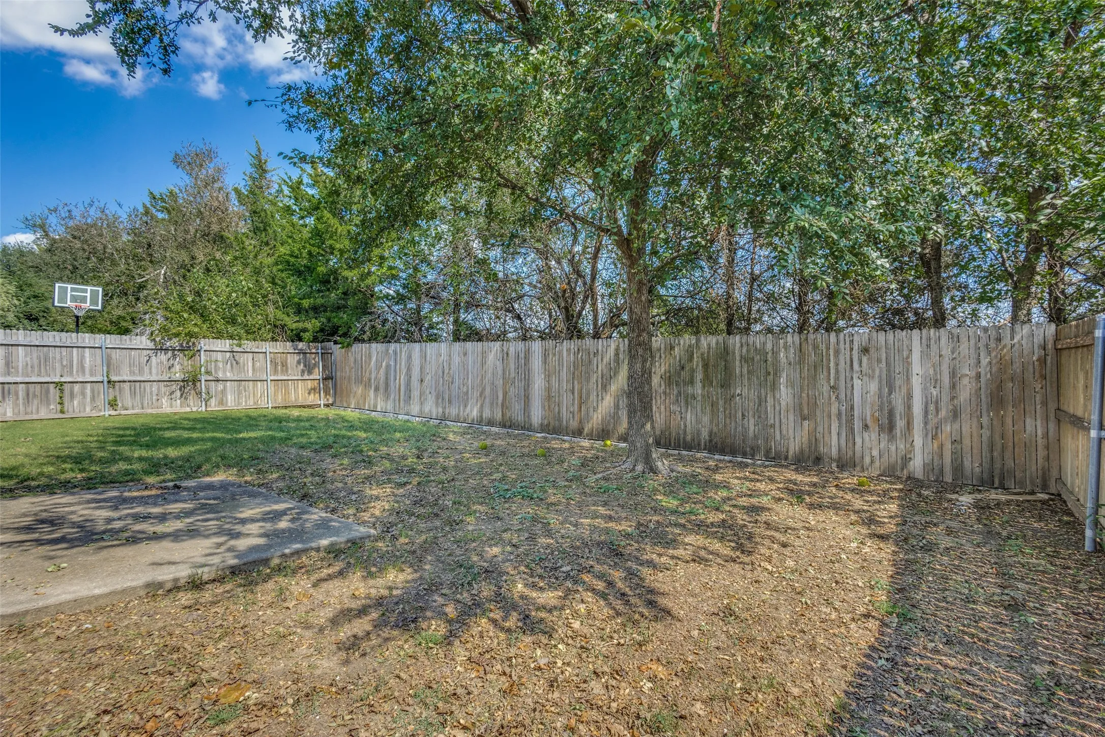 Fenced backyard with a patio
