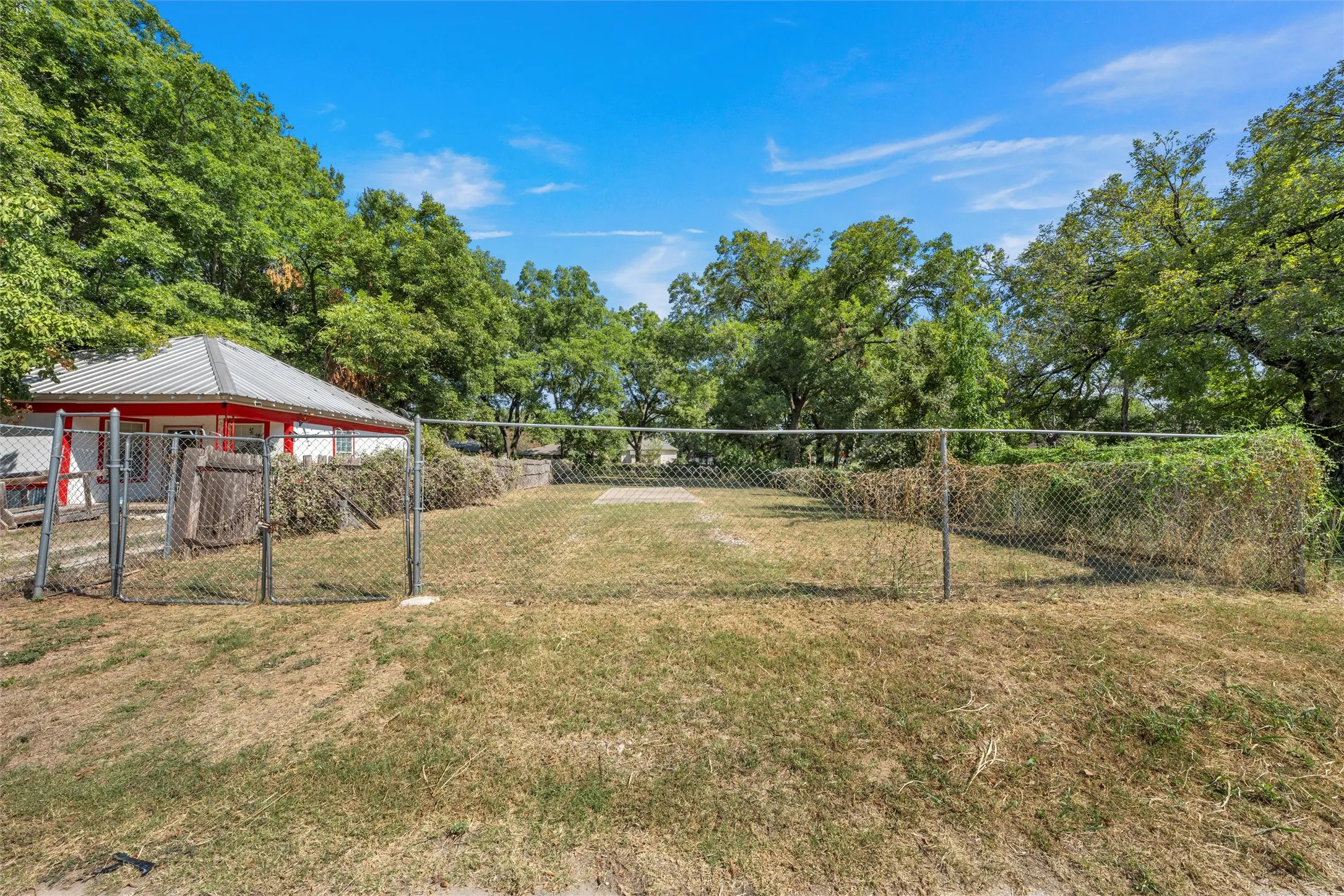 Surrounding community with view of wooded area