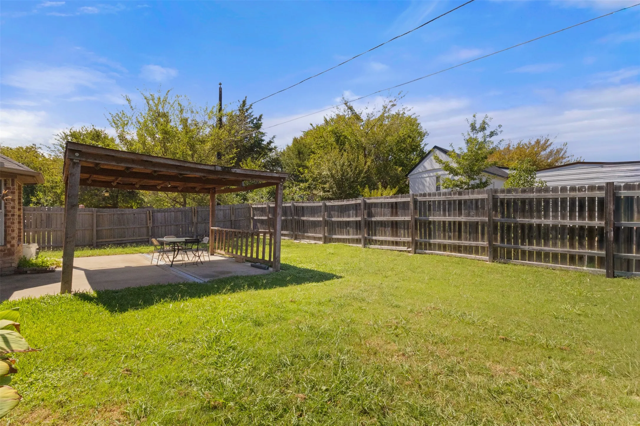 Fenced backyard featuring a patio
