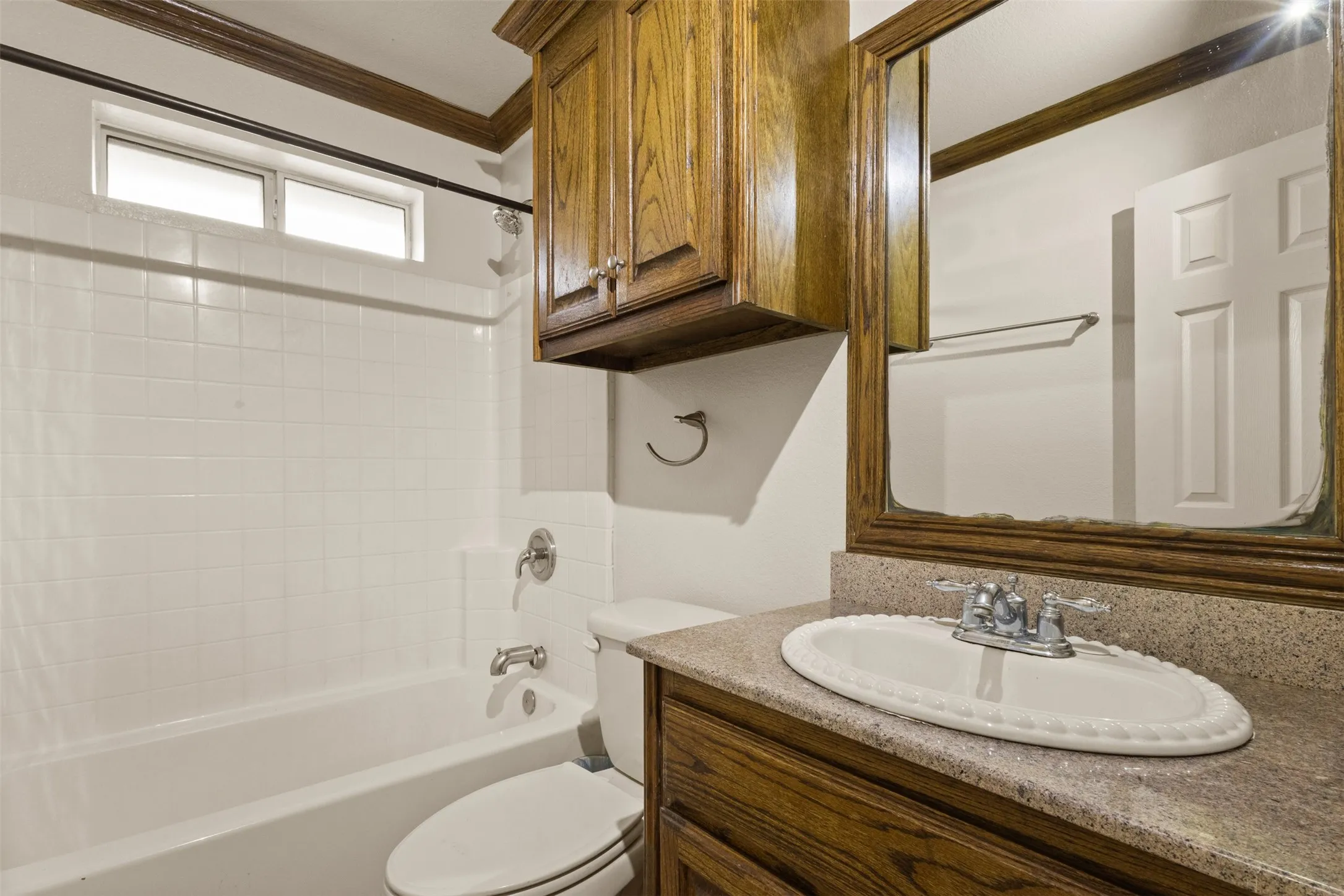 Full bath with shower / bath combination, vanity, and crown molding