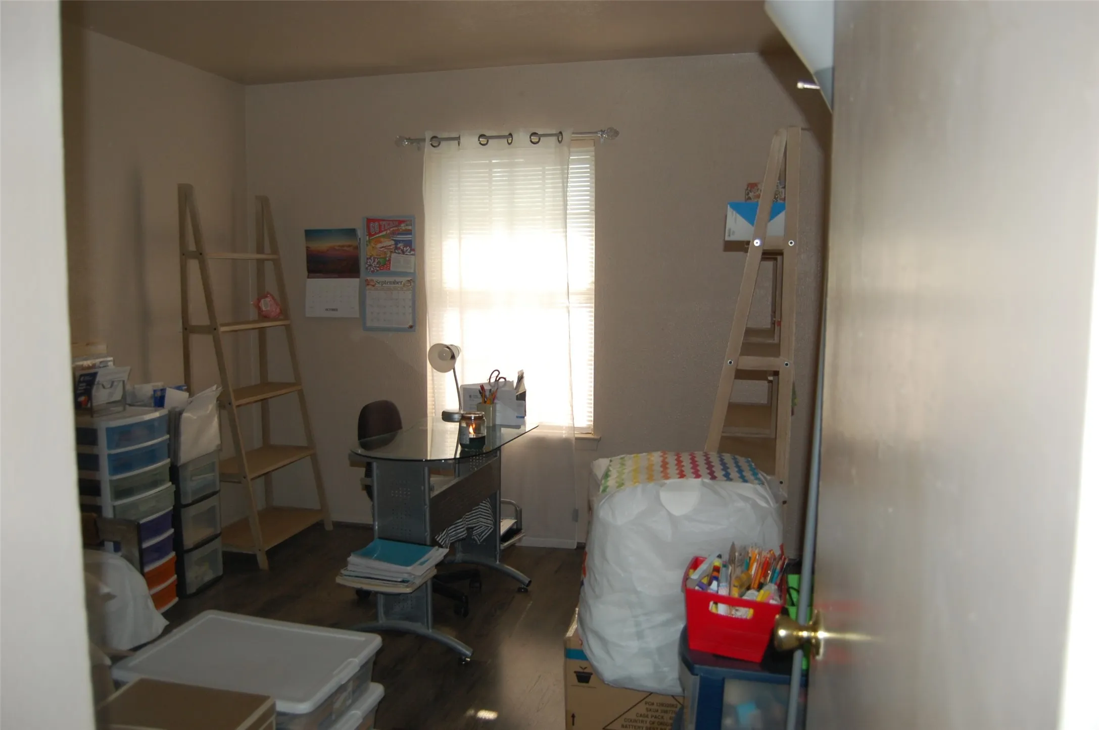 Bedroom as Home office featuring dark wood finished floors