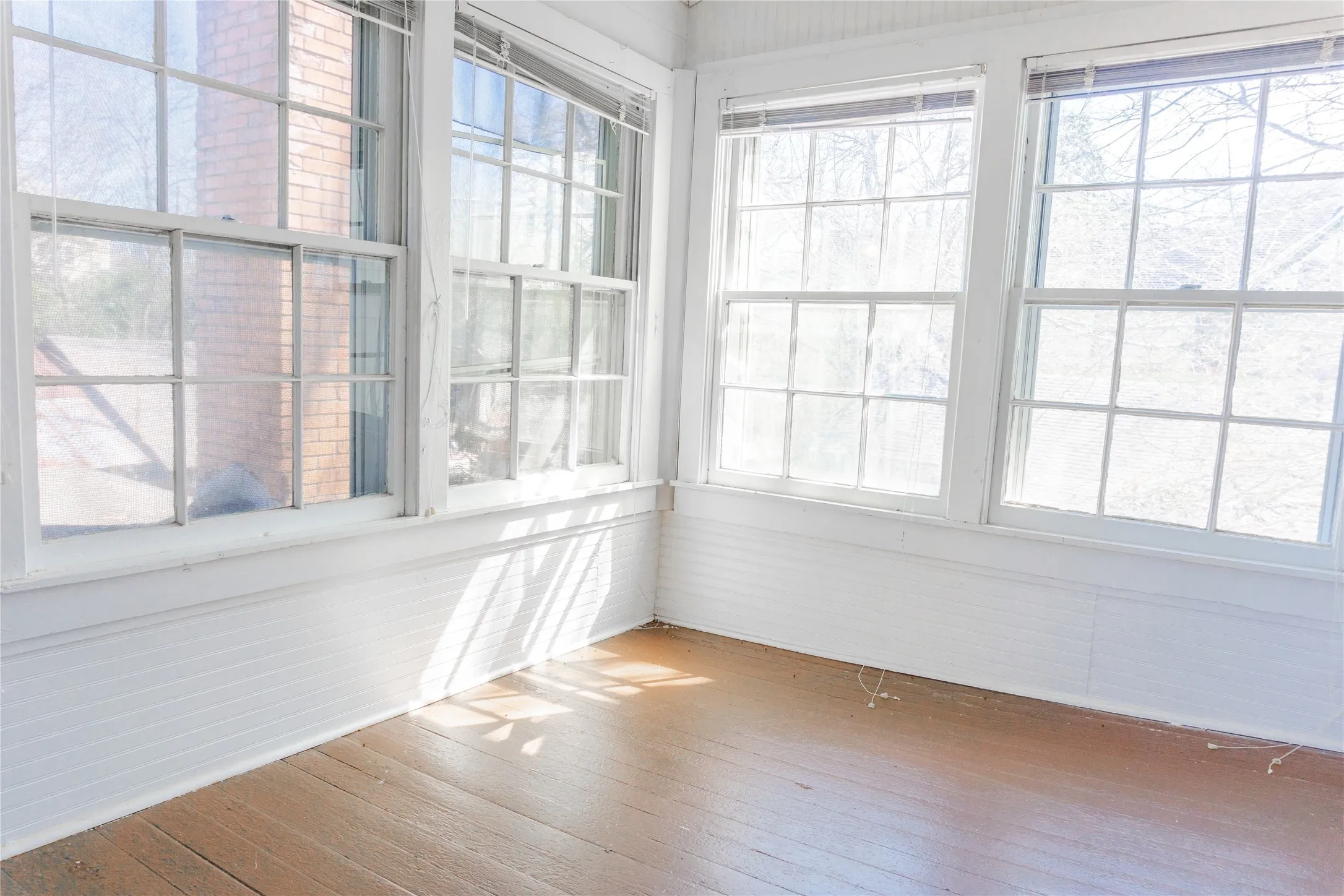 Unfurnished sunroom with wood-type flooring
