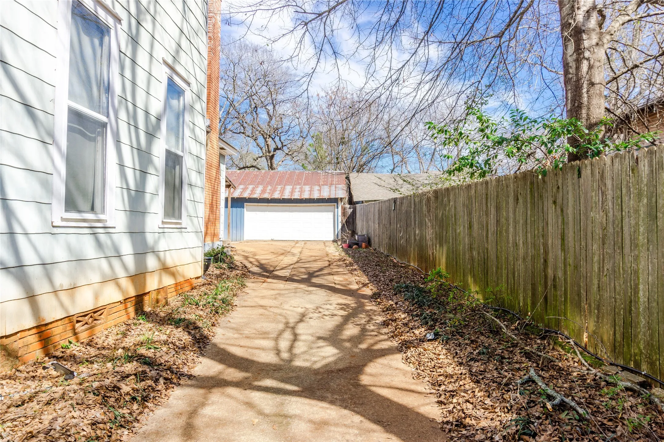 View of yard featuring a garage and driveway