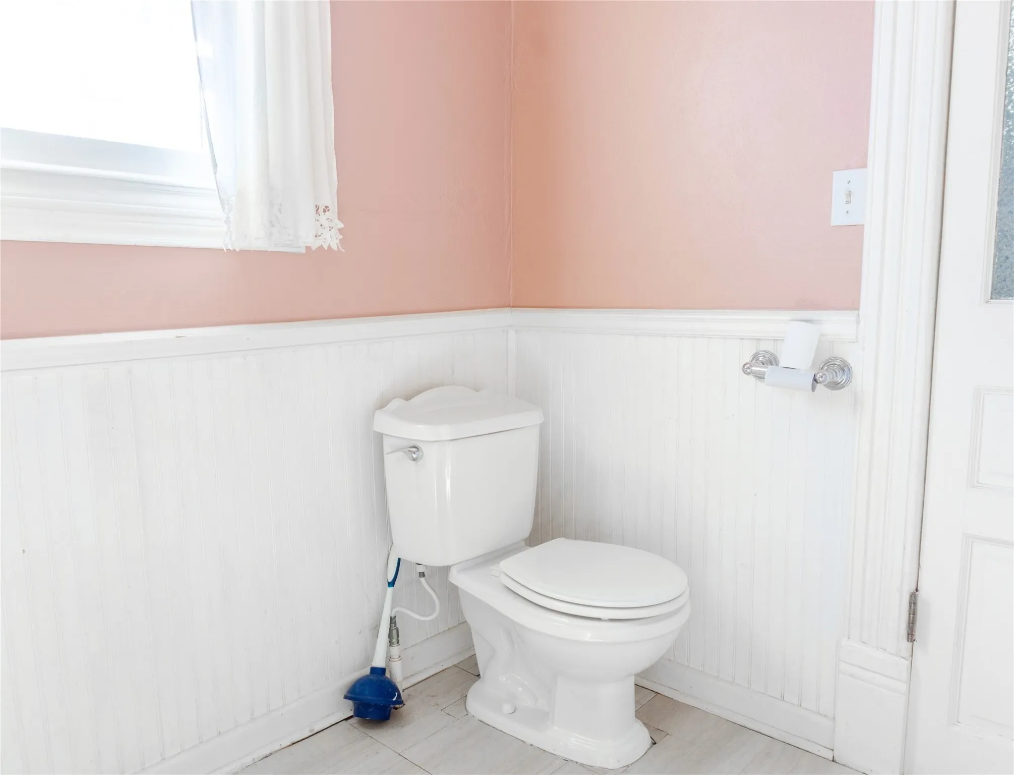 Bathroom featuring a wainscoted wall and tile patterned floors
