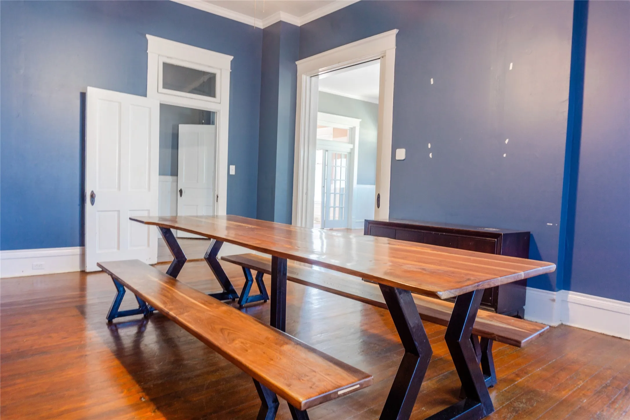 Dining area with dark wood finished floors and ornamental molding