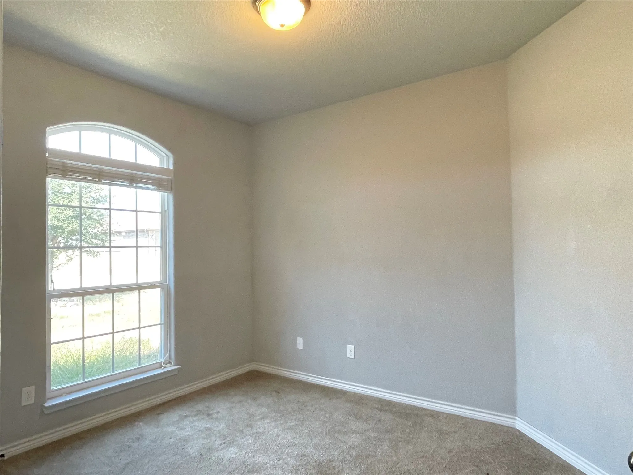 Second bedroom with carpet flooring, could be office