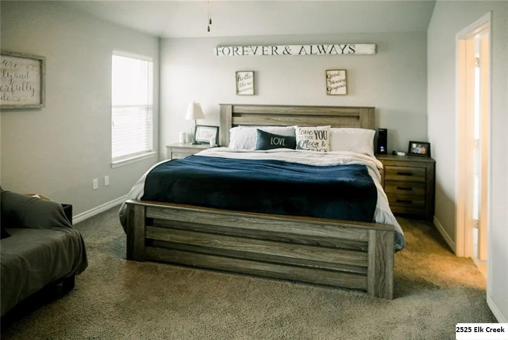 Primary bedroom with a ceiling fan