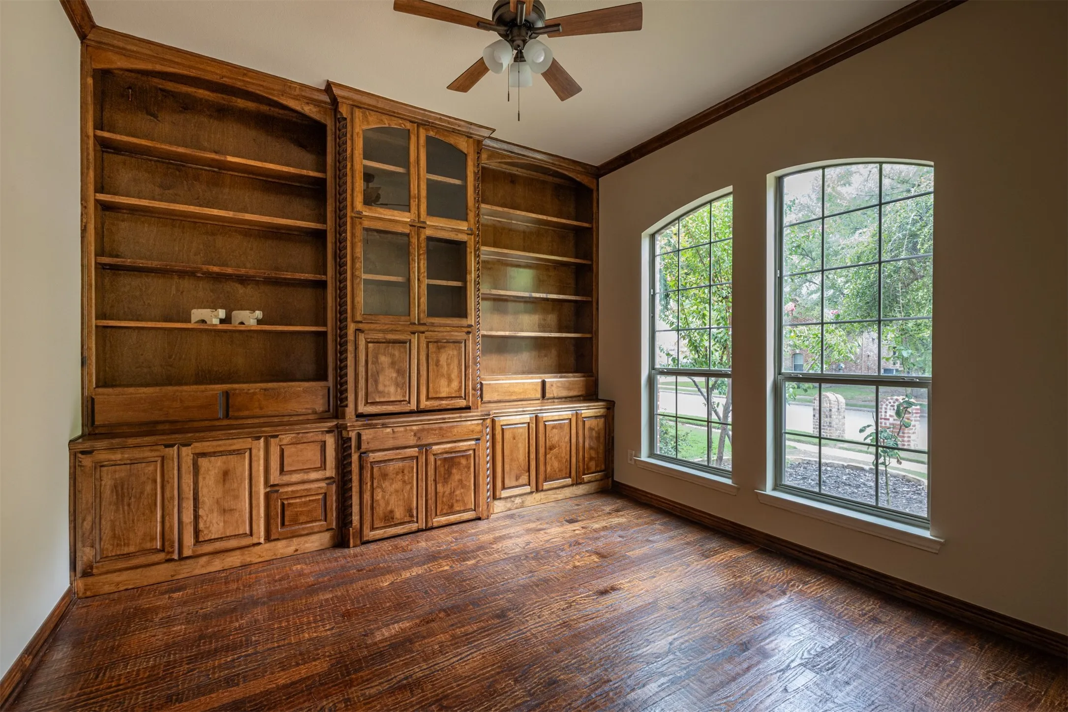 Stunning Office/Study with beautiful floor to ceiling built-ins, hardwood, and french doors providing privacy (great view of the front scapes and trails